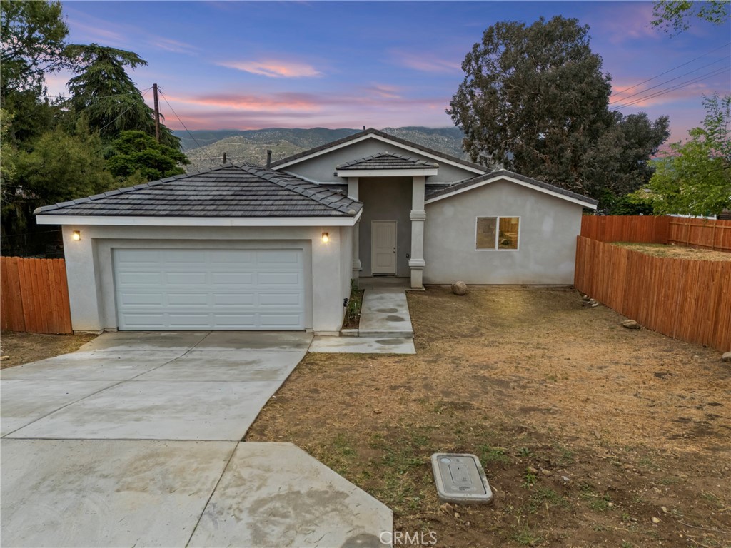 230 East Hoffer Street Banning, CA 92220 - Photo 2 of 32 a view of a house with a yard and garage