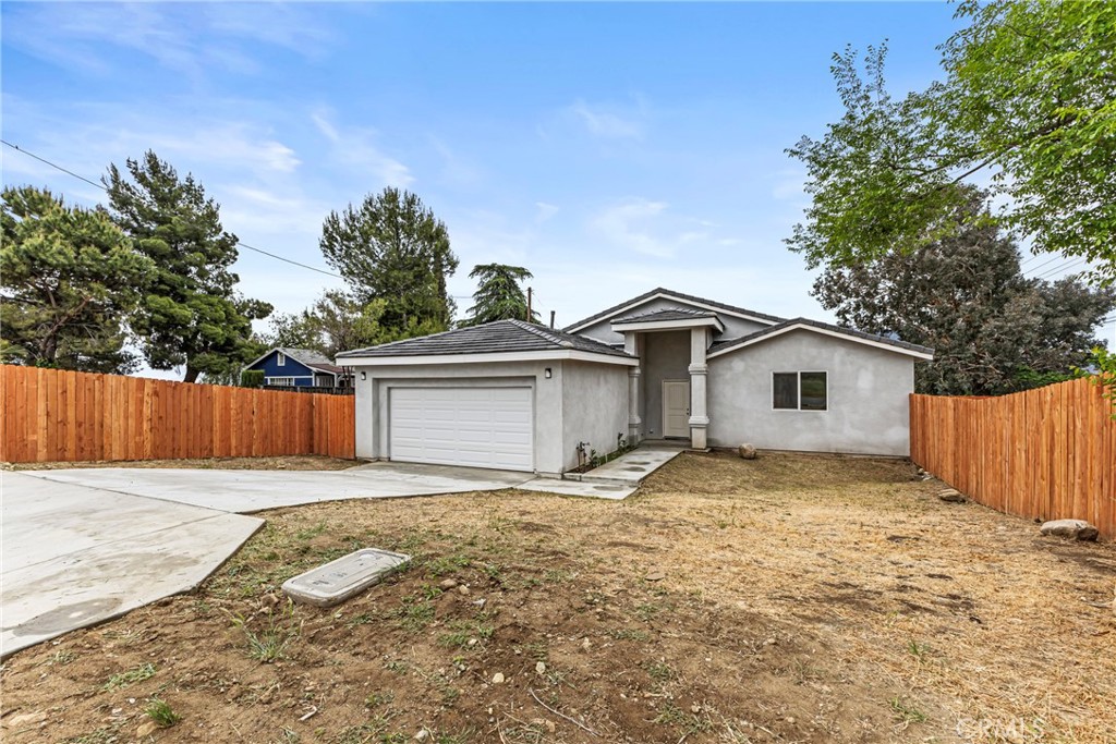 230 East Hoffer Street Banning, CA 92220 - Photo 22 of 32 a view of a house with a yard and large tree
