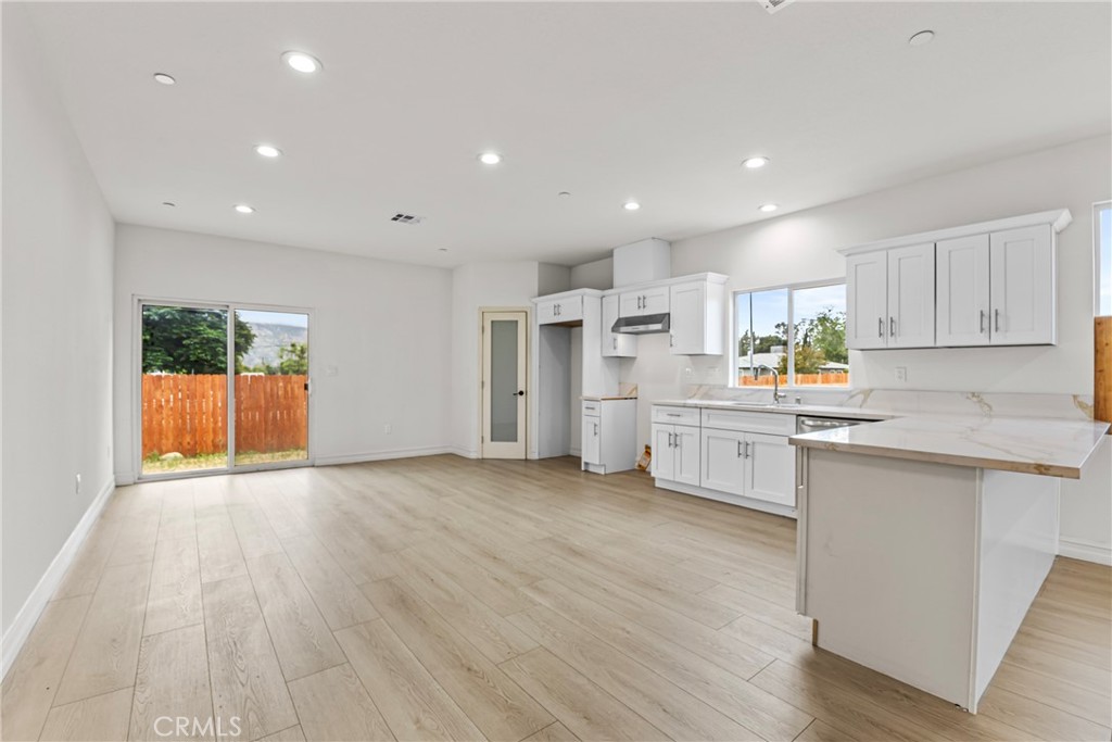 230 East Hoffer Street Banning, CA 92220 - Photo 4 of 32 a kitchen with stainless steel appliances a refrigerator sink and white cabinets