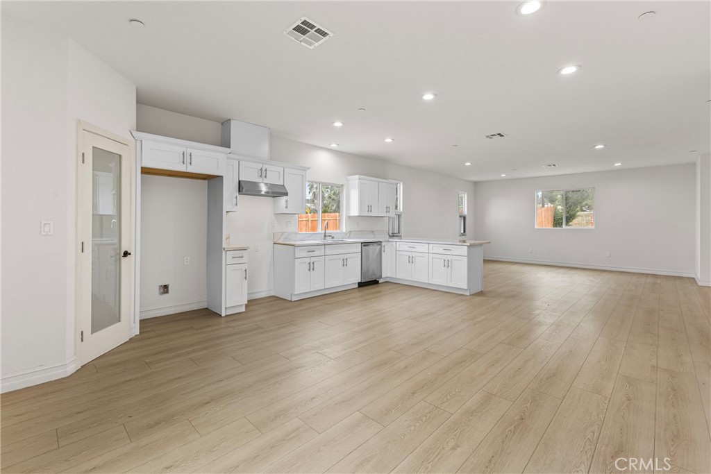 230 East Hoffer Street Banning, CA 92220 - Photo 8 of 32 a view of kitchen with wooden floor and windows