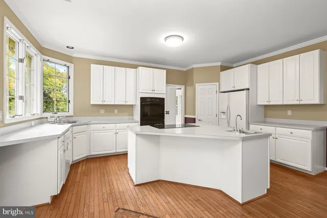 a view of an empty room with a window and fireplace