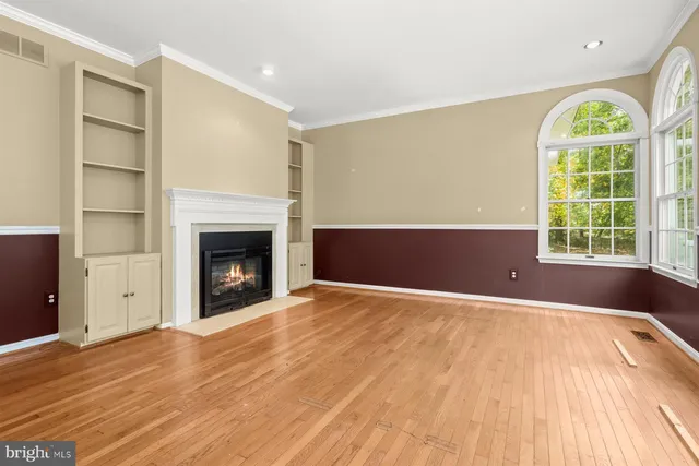 a view of a white house with wooden floor and a large window