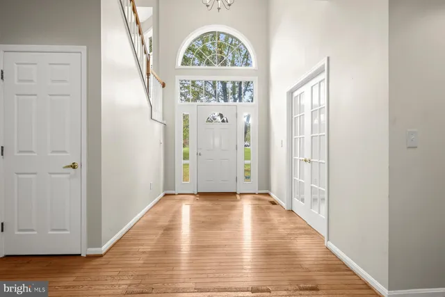 an empty room with windows and view of bathroom