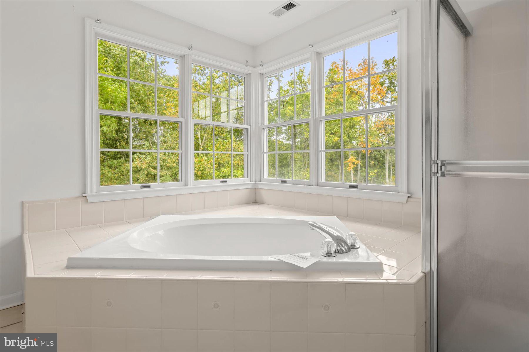 3360 Lawndale Road Reisterstown, MD 21136 - Photo 40 of 63 a white bath tub sitting in a bathroom next to a window