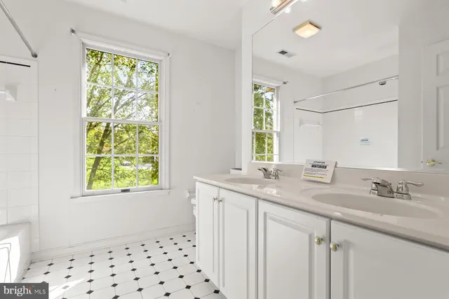 a view of a house with a big yard and large trees
