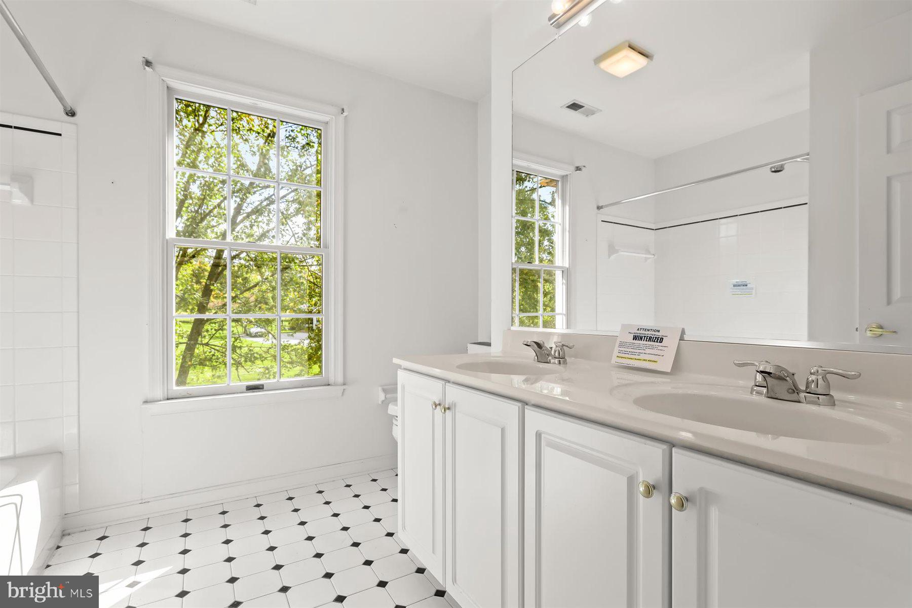 3360 Lawndale Road Reisterstown, MD 21136 - Photo 45 of 63 a bathroom with a granite countertop sink a mirror a window and a shower