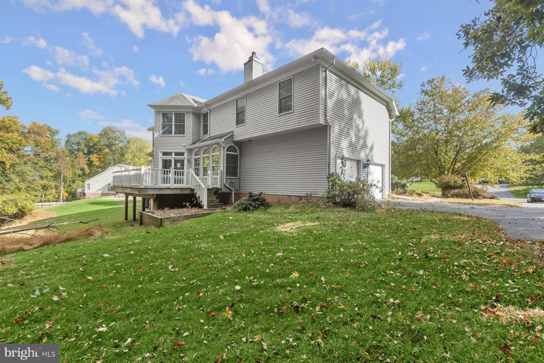 3360 Lawndale Road Reisterstown, MD 21136 - Photo 56 of 63 a white house that has a small yard and large trees