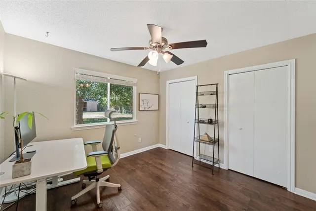 a workspace with wooden floor and a window