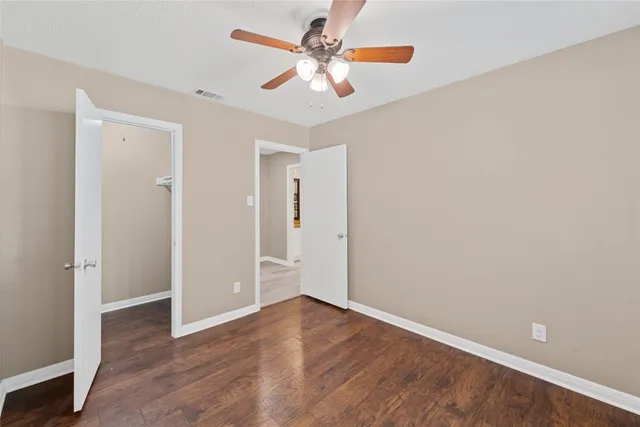 a bathroom with a granite countertop sink toilet a mirror a vanity and shower