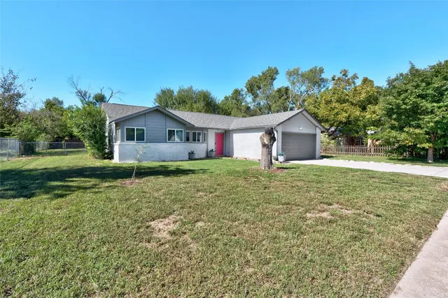 a view of backyard of house with green space