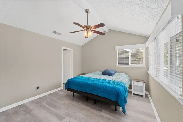 a bathroom with a granite countertop sink a mirror and a shower