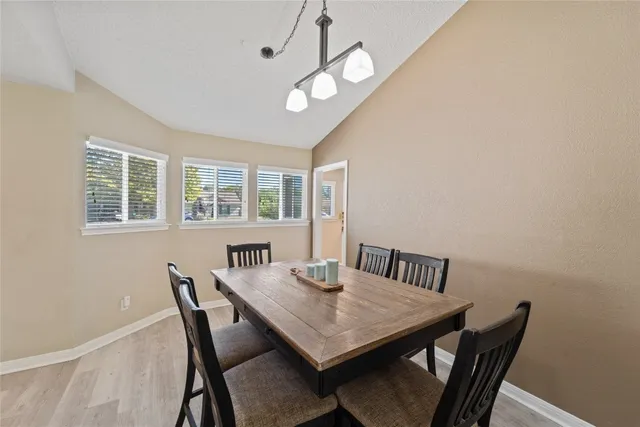 a kitchen with granite countertop a sink stove and refrigerator
