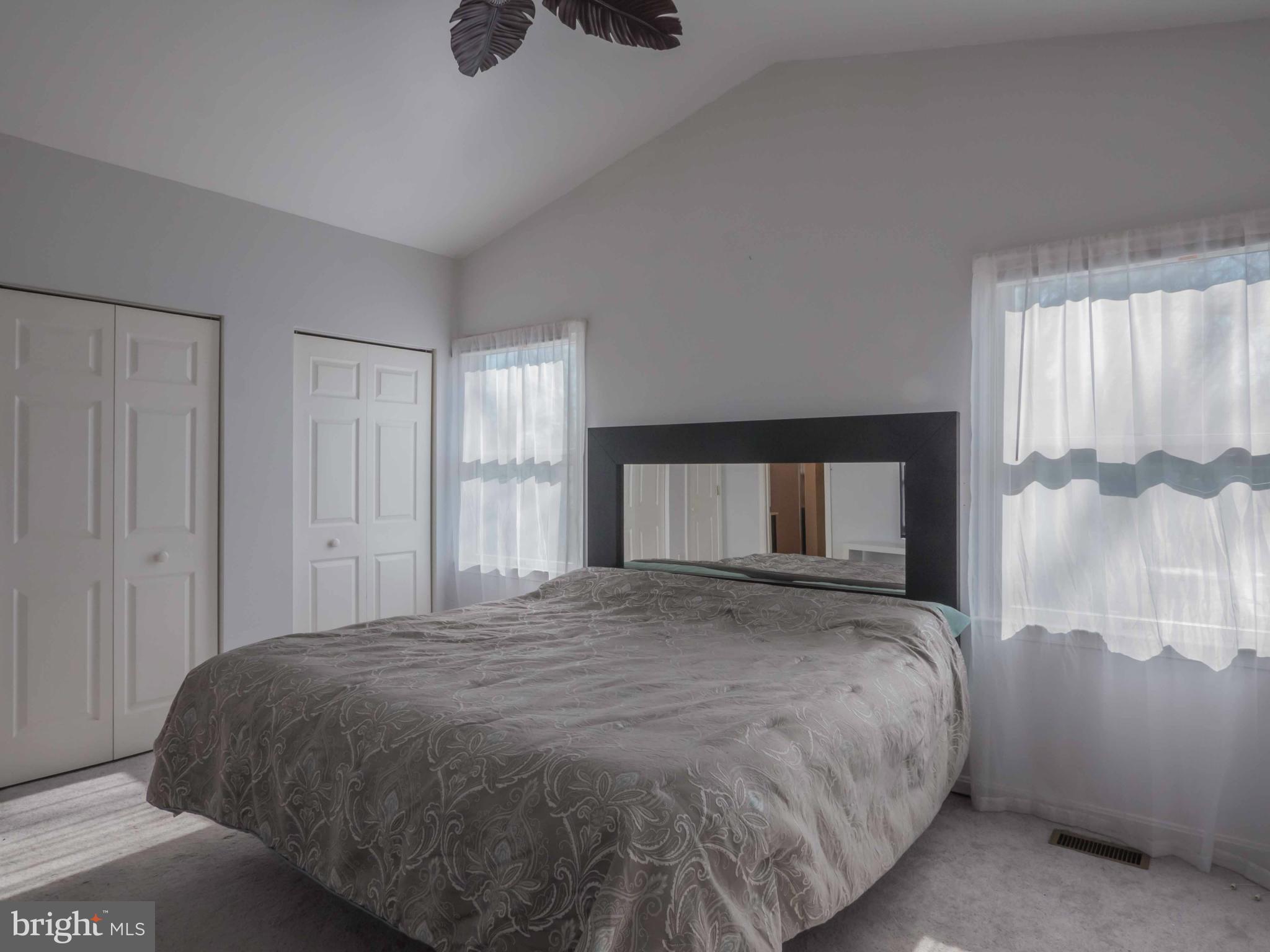 413 Salisbury Road Edgewater, MD 21037 - Photo 11 of 30 a large bed sitting in a bedroom next to a window and a chandelier