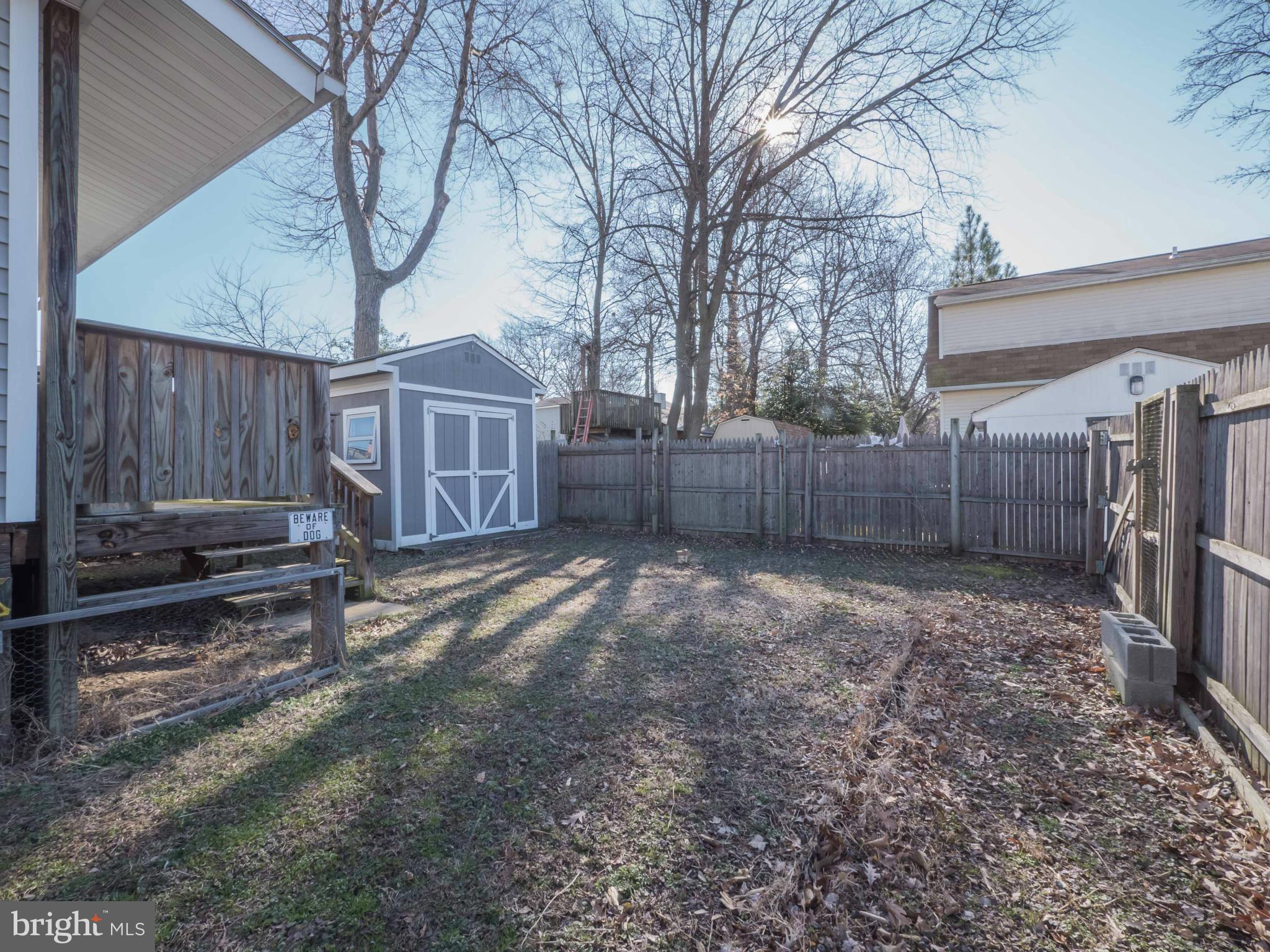 413 Salisbury Road Edgewater, MD 21037 - Photo 26 of 30 a view of a backyard with a small cabin and wooden fence