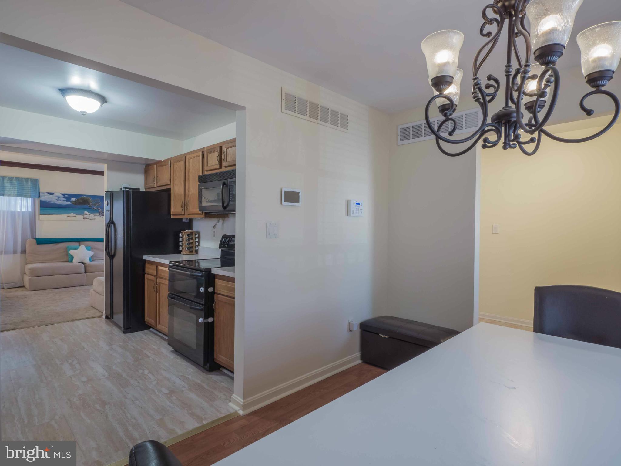 413 Salisbury Road Edgewater, MD 21037 - Photo 5 of 30 a kitchen with a refrigerator and a stove top oven