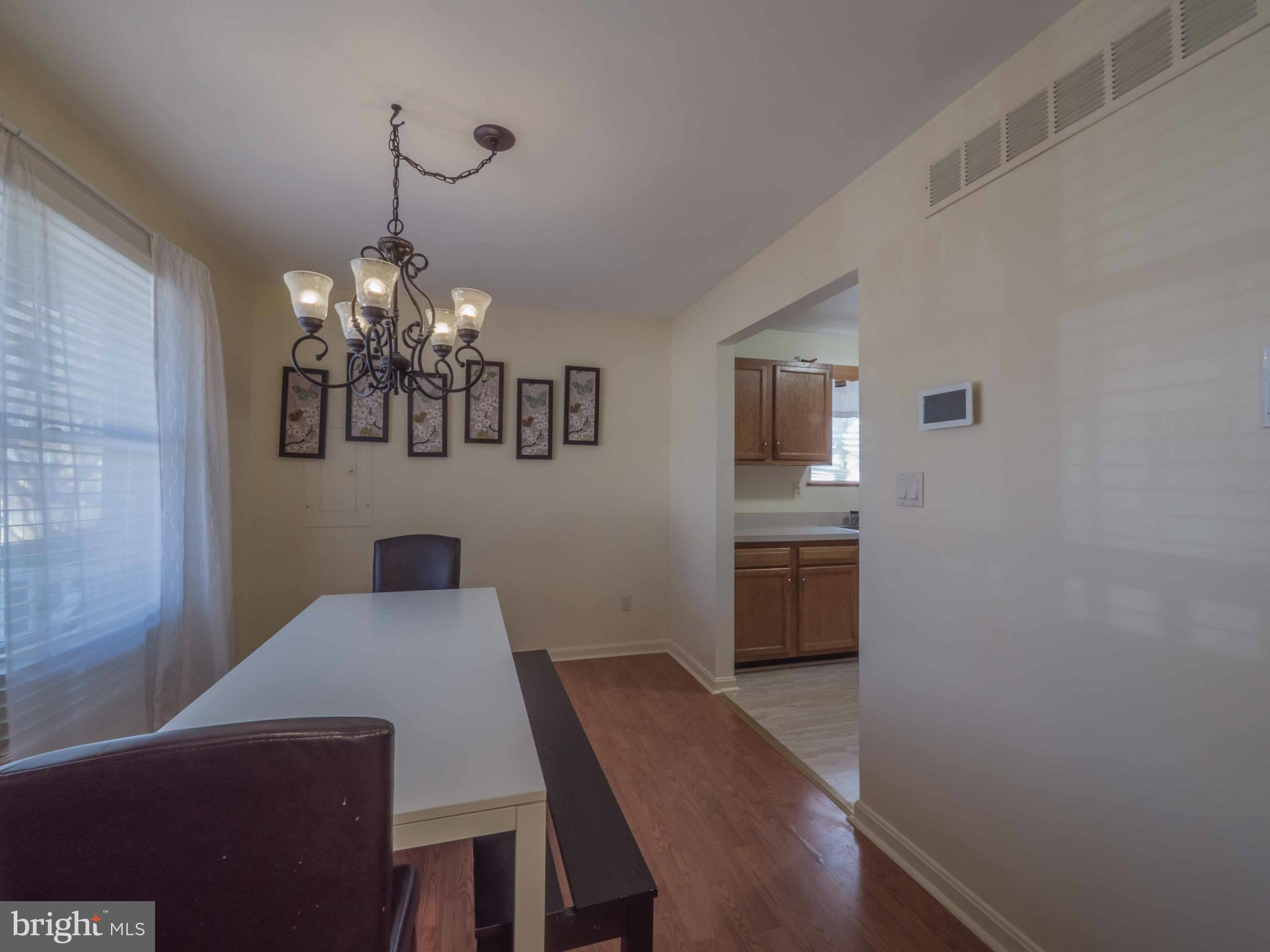 413 Salisbury Road Edgewater, MD 21037 - Photo 7 of 30 a view of a dining room with furniture and wooden floor
