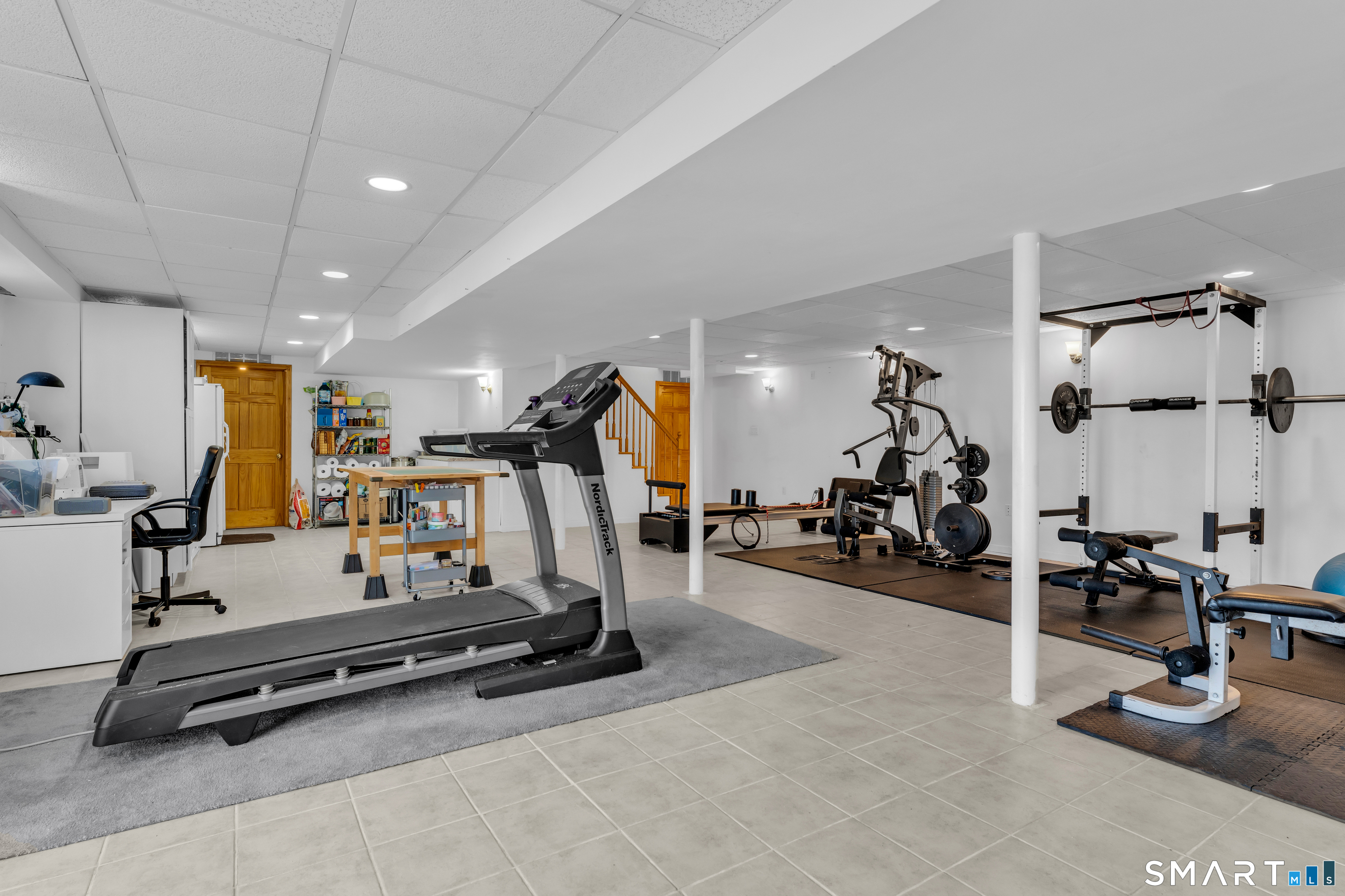 322 Willow Road Guilford, CT 06437 - Photo 31 of 40 Partially finished basement with additional unfinished space for mechanicals and storage.