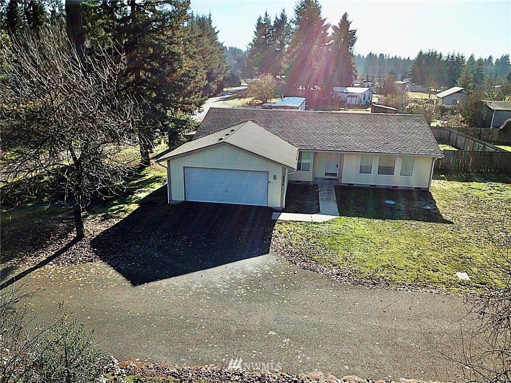 9836 179th Way Southwest Rochester, WA 98579 - Photo 1 of 26 a front view of a house with a yard and garage