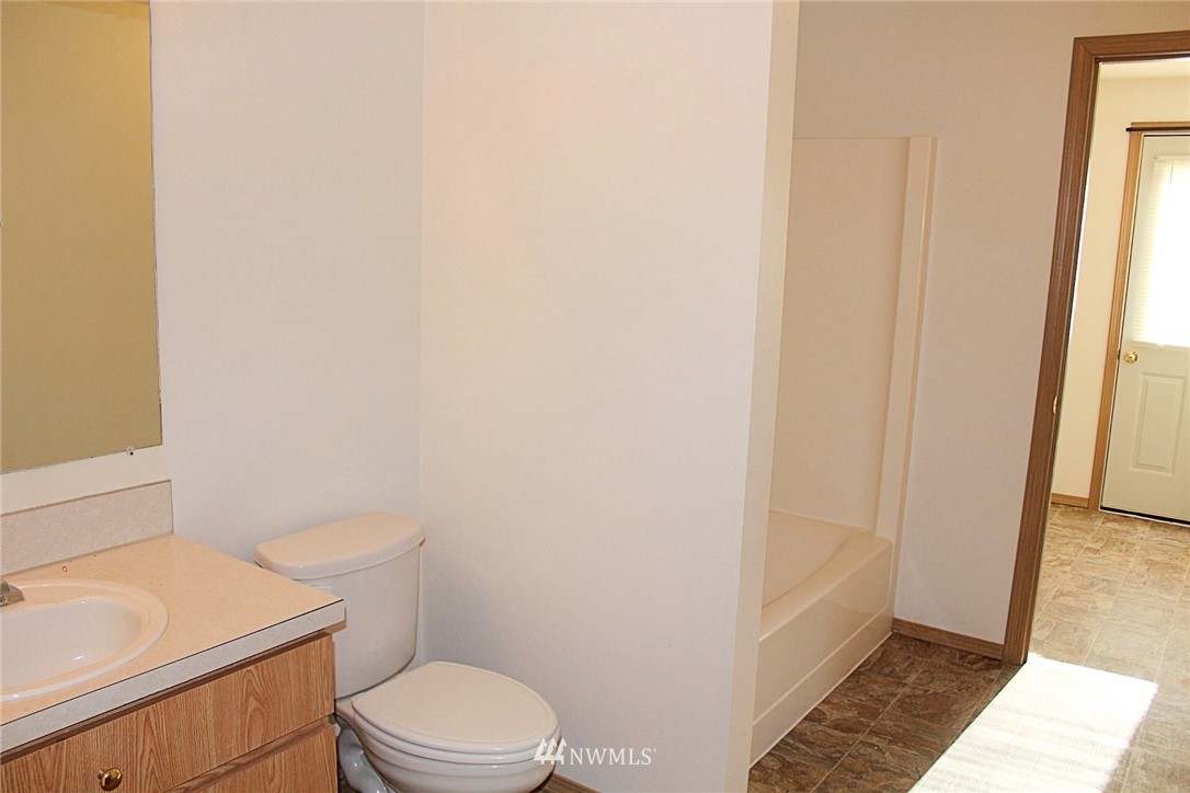 9836 179th Way Southwest Rochester, WA 98579 - Photo 19 of 26 a white toilet sitting next to a bathroom sink