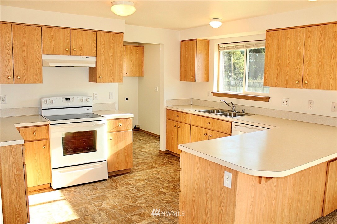 9836 179th Way Southwest Rochester, WA 98579 - Photo 5 of 26 a kitchen with a stove a sink and a refrigerator