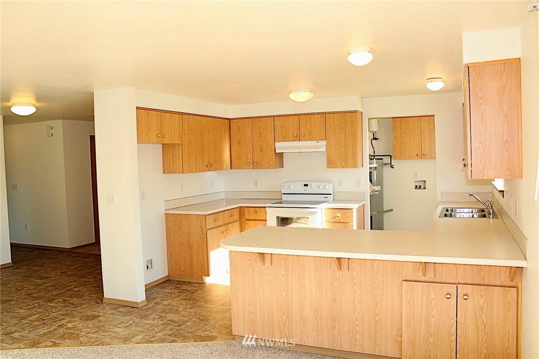 9836 179th Way Southwest Rochester, WA 98579 - Photo 6 of 26 a kitchen with stainless steel appliances a stove a refrigerator and cabinets