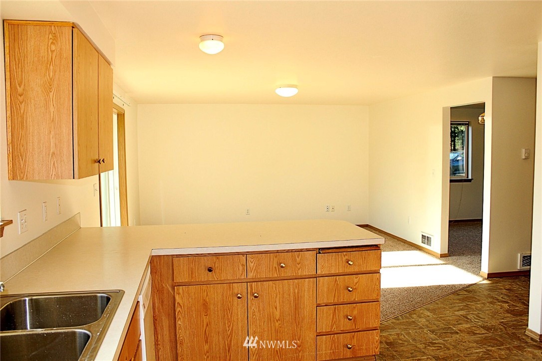 9836 179th Way Southwest Rochester, WA 98579 - Photo 7 of 26 a kitchen with a sink a stove and a refrigerator
