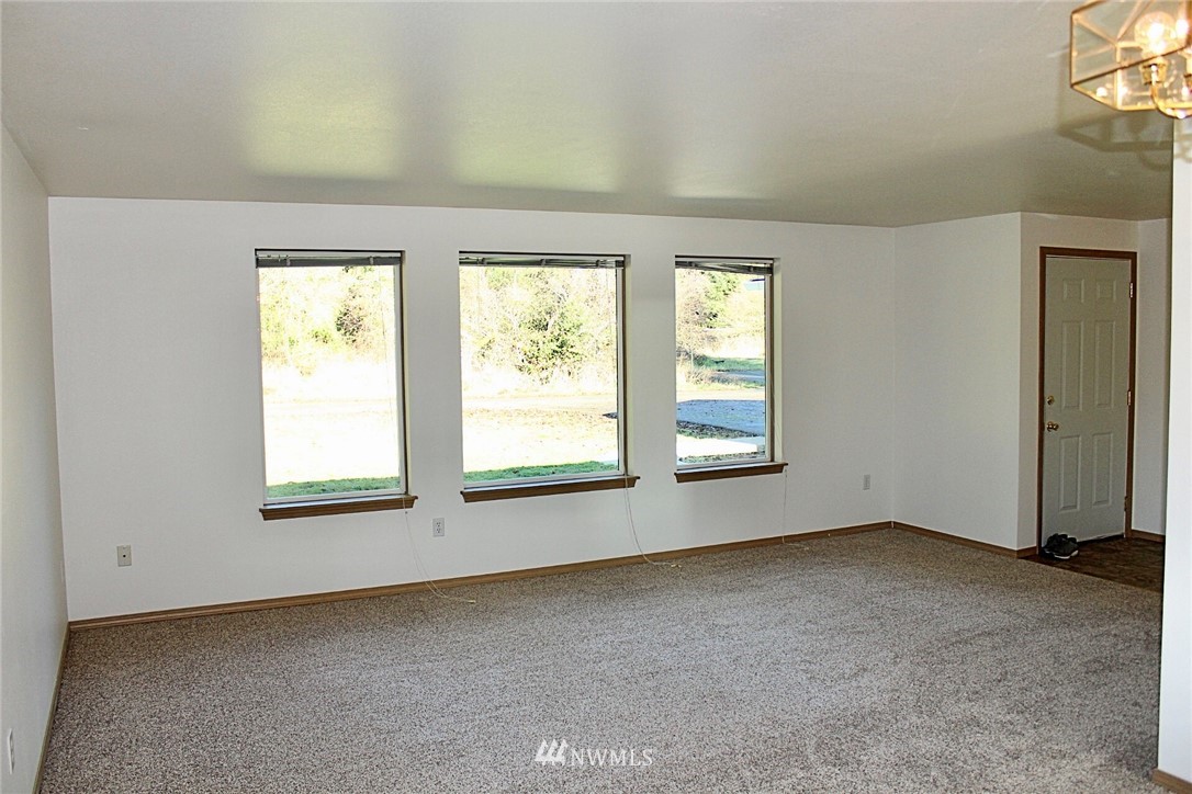 9836 179th Way Southwest Rochester, WA 98579 - Photo 9 of 26 an empty room with windows