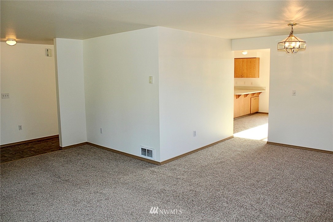 9836 179th Way Southwest Rochester, WA 98579 - Photo 10 of 26 a view of a room with a hallway and a chandelier