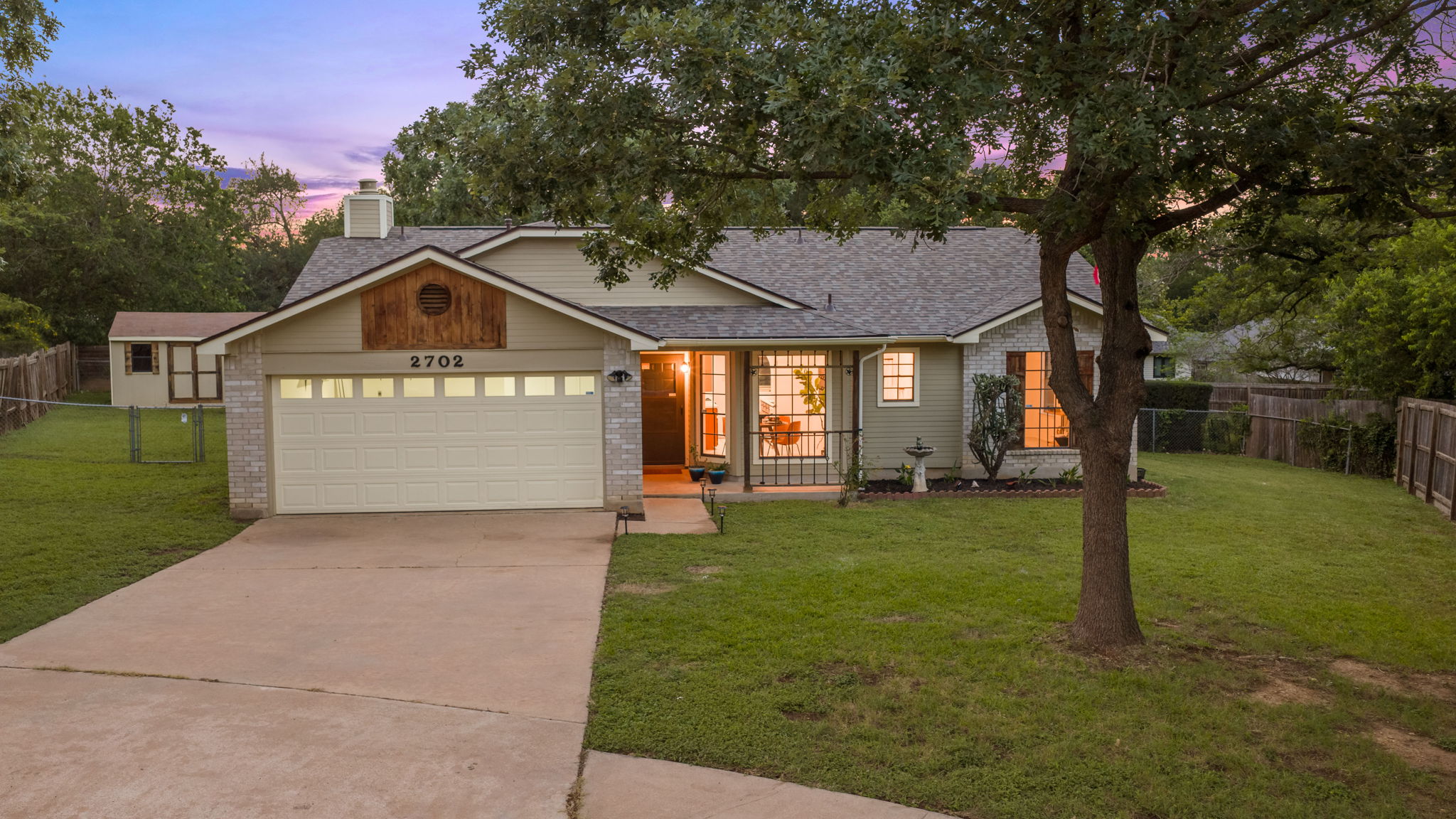 2702 Calabash Cove Austin, TX 78745 - Photo 40 of 40 a front view of a house with a yard and garage