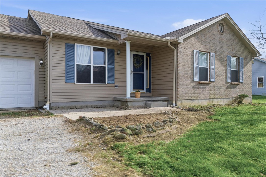 8747 Waynes Way Blanchester, OH 45107 - Photo 28 of 40 This charming home features a welcoming entryway with a covered porch and an attached garage.