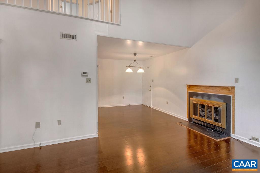 140 Tulip Road Ruckersville, VA 22968 - Photo 6 of 42 a view of a hallway with wooden floor and a refrigerator