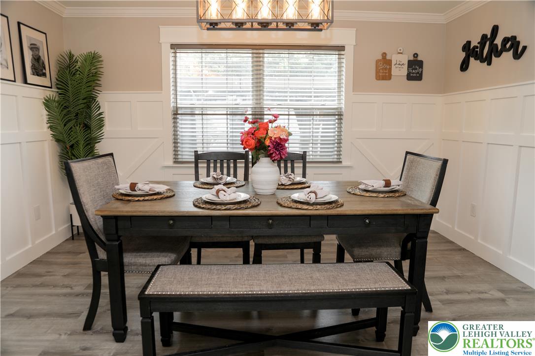 1412 Stanford Road Bethlehem, PA 18018 - Photo 12 of 58 Board and batten wainscoting frames this inviting dining area, crowned by a distinctive linear chandelier.