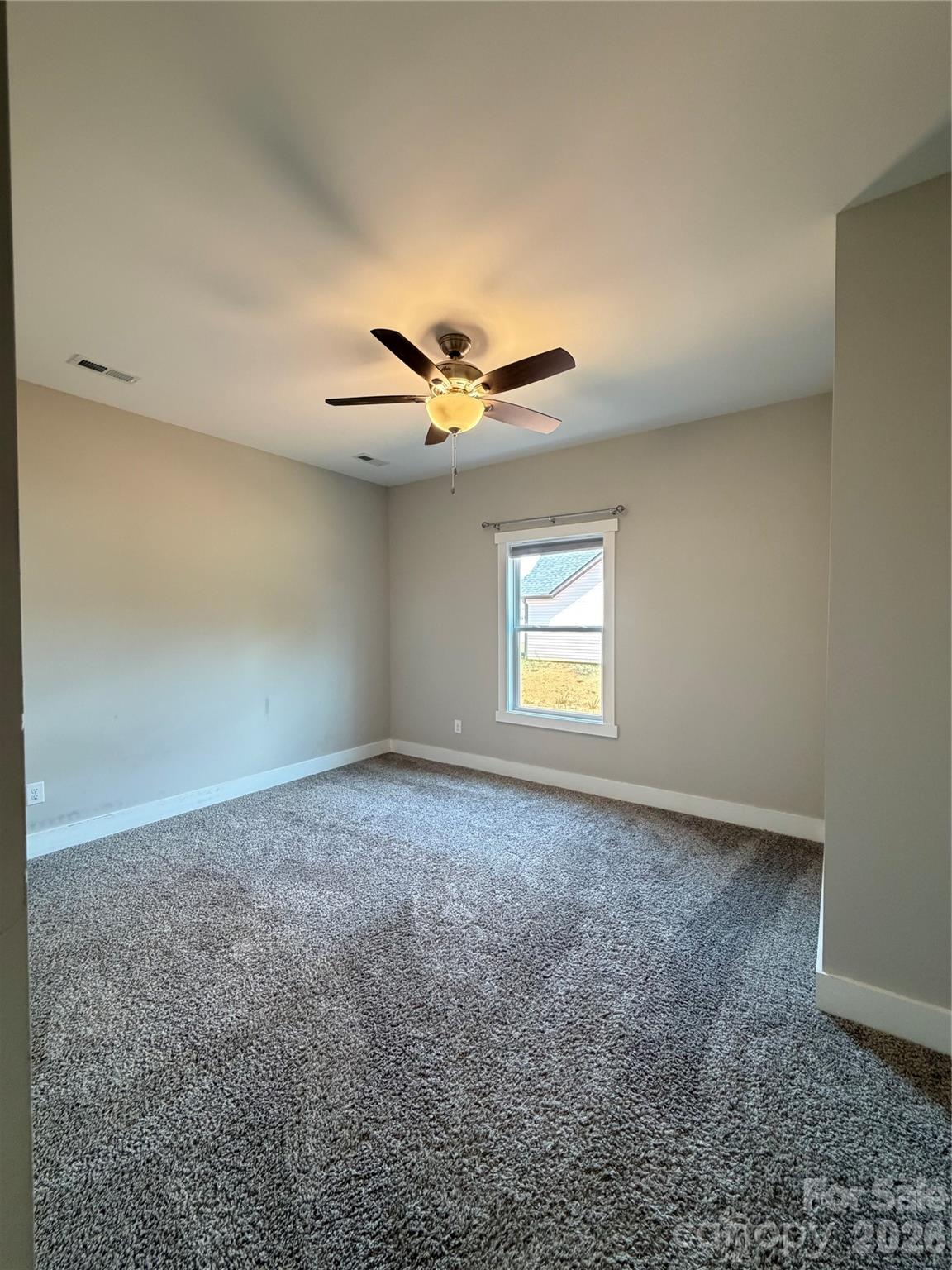 1473 Pleasant School Road Gaffney, SC 29341 - Photo 14 of 16 an empty room with a window and a ceiling fan