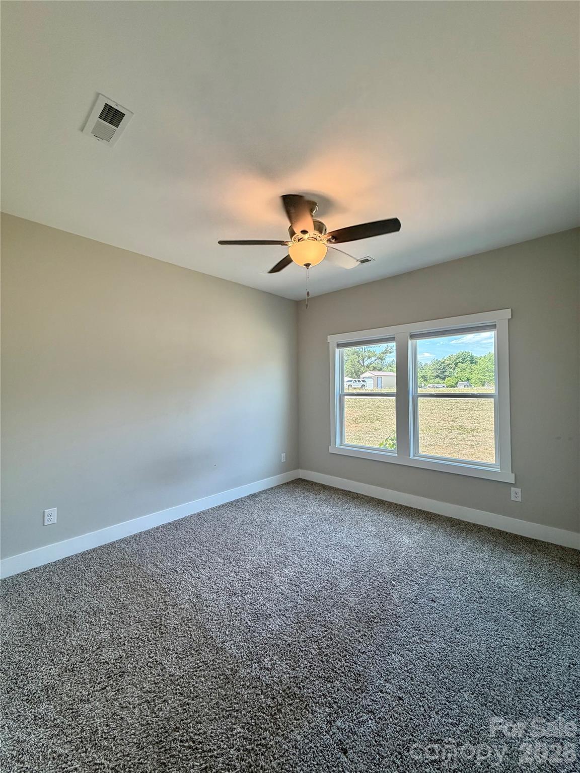1473 Pleasant School Road Gaffney, SC 29341 - Photo 16 of 16 an empty room with a ceiling fan and window