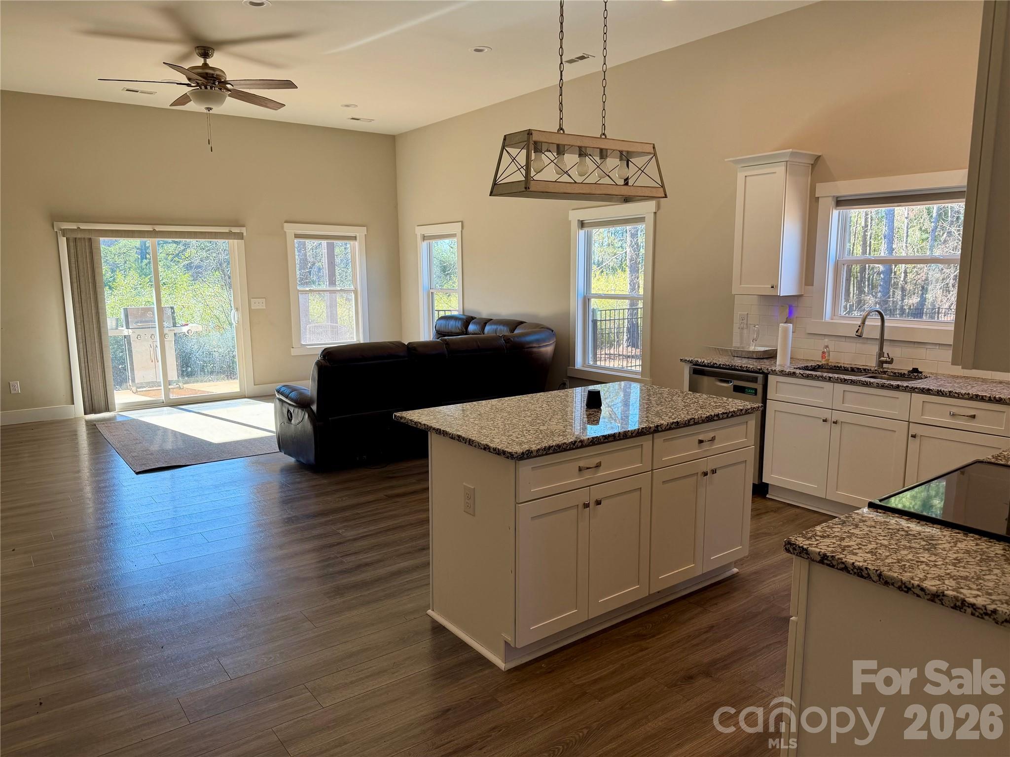 1473 Pleasant School Road Gaffney, SC 29341 - Photo 2 of 2 a kitchen with granite countertop a sink cabinets and wooden floor