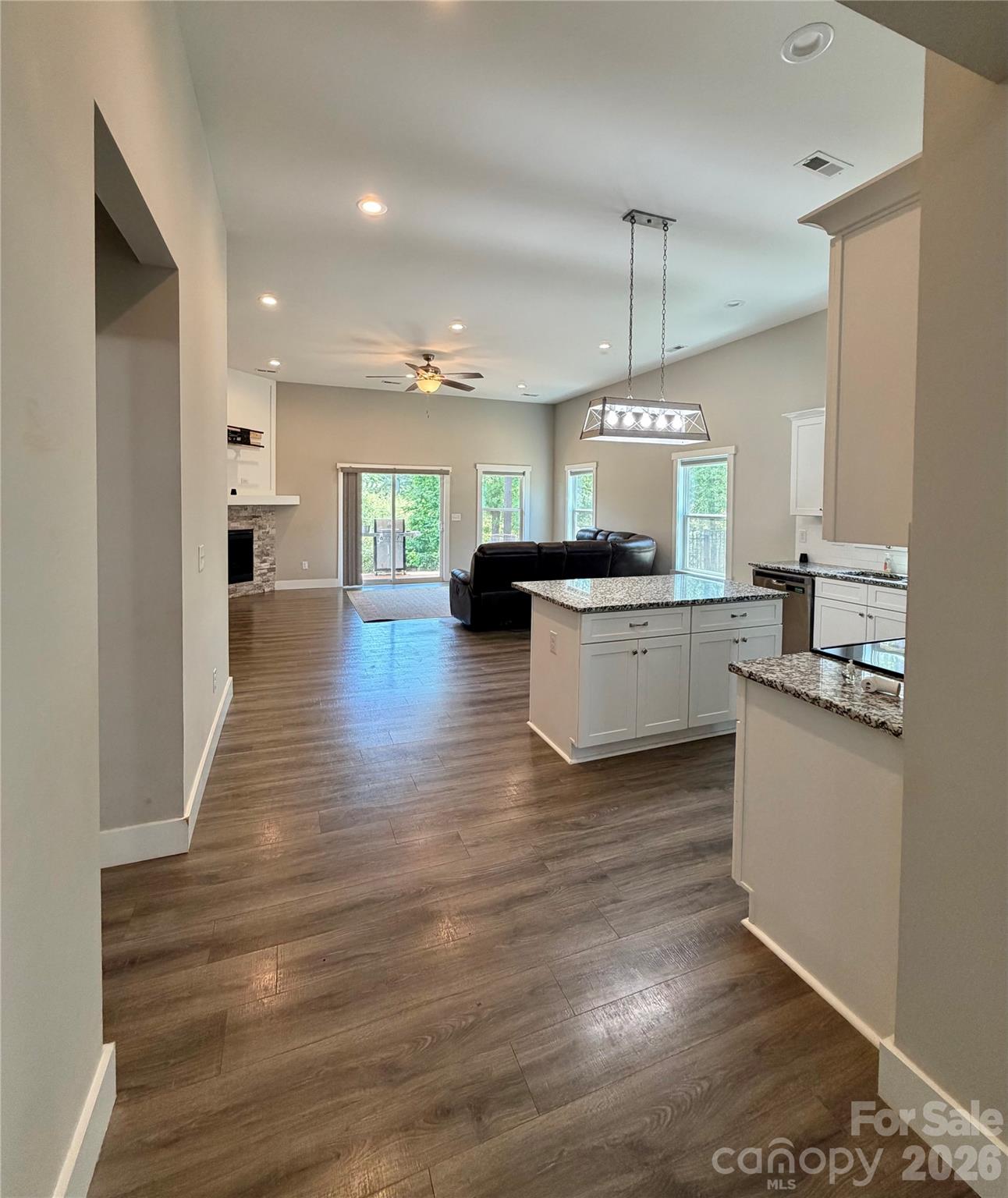 1473 Pleasant School Road Gaffney, SC 29341 - Photo 6 of 16 a kitchen with kitchen island granite countertop a sink cabinets and wooden floor