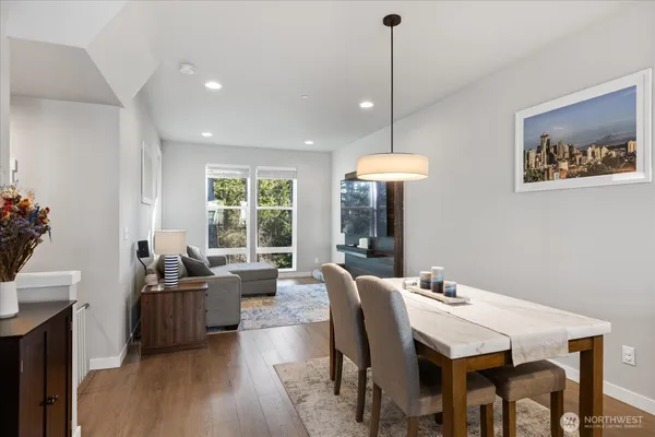 a view of a dining room with furniture window and wooden floor