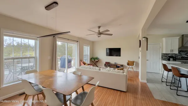 a dining room with furniture and wooden floor