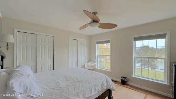 a view of a room with furniture and wooden floor