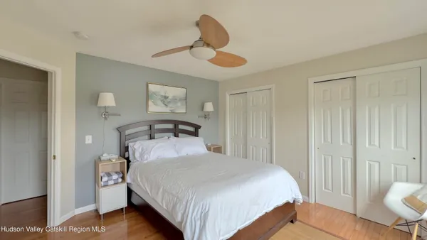 a bedroom with a bed and a night stand