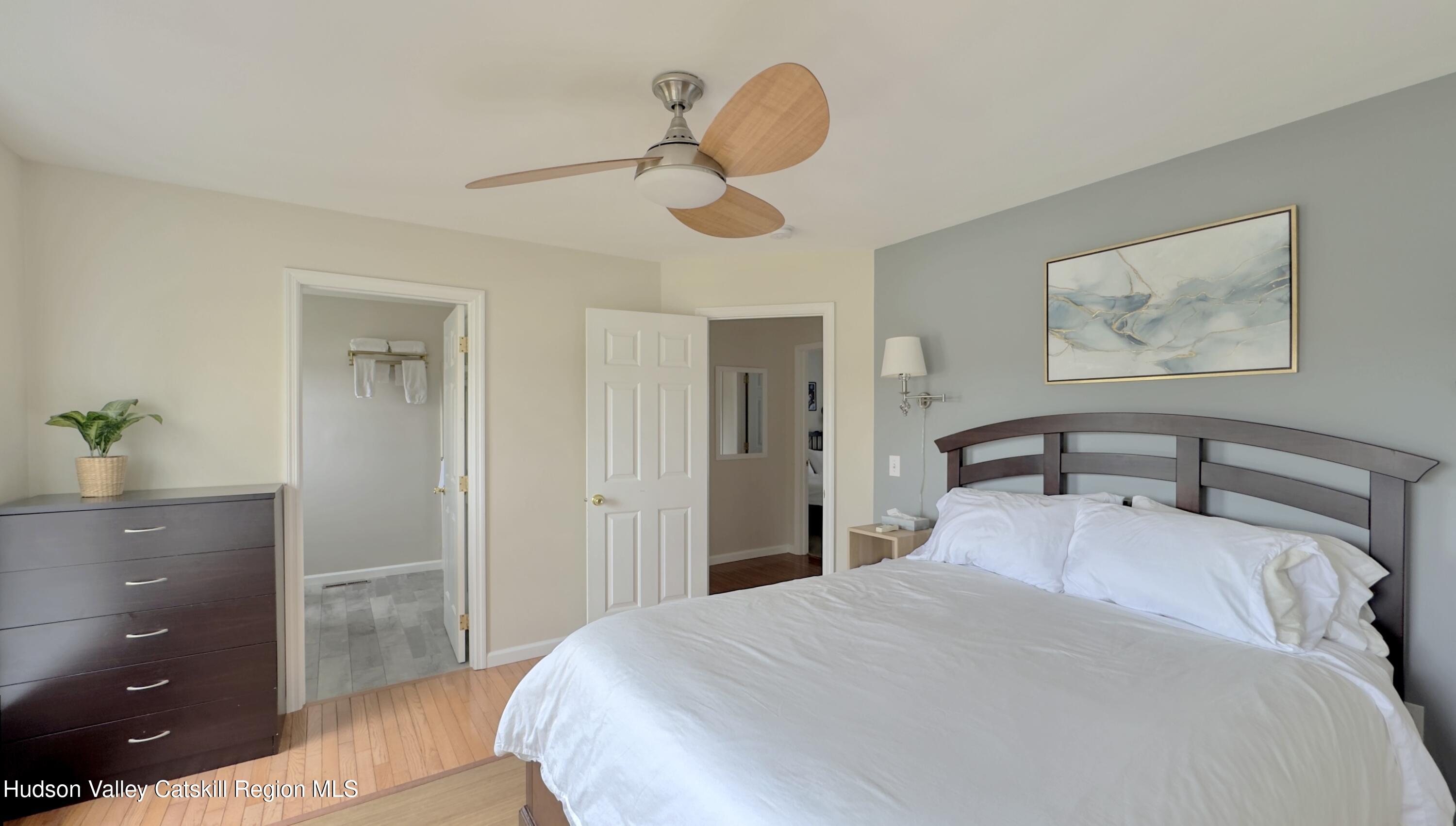 70 Travis Place Athens, NY 12015 - Photo 22 of 57 a bedroom with a bed and a chandelier