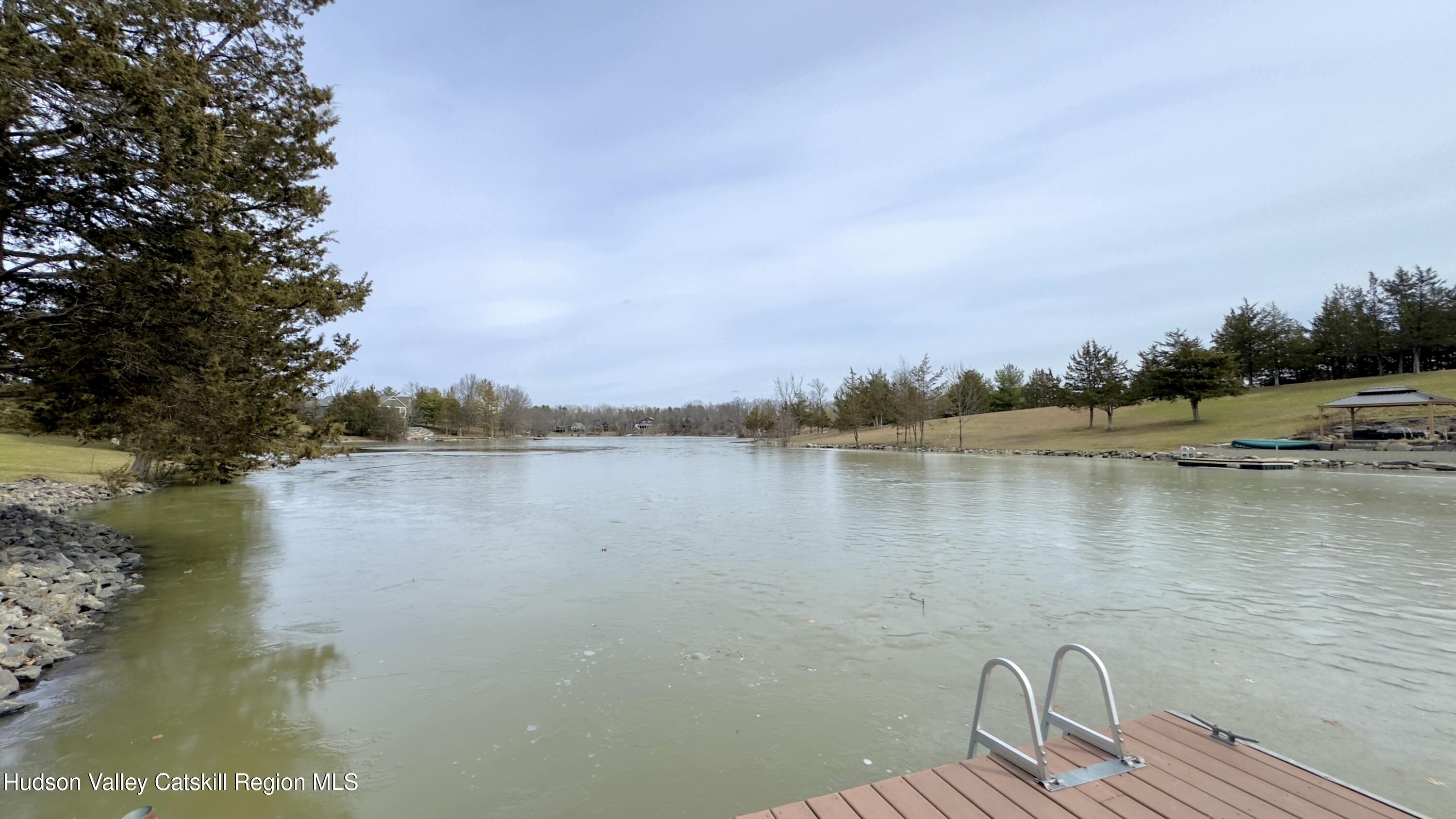 70 Travis Place Athens, NY 12015 - Photo 50 of 57 a view of a lake with houses in the back