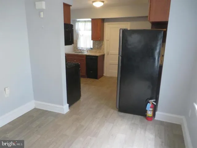 a kitchen with refrigerator and window