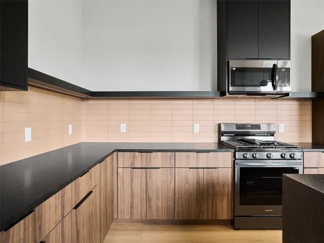 a stove top oven sitting inside of a kitchen