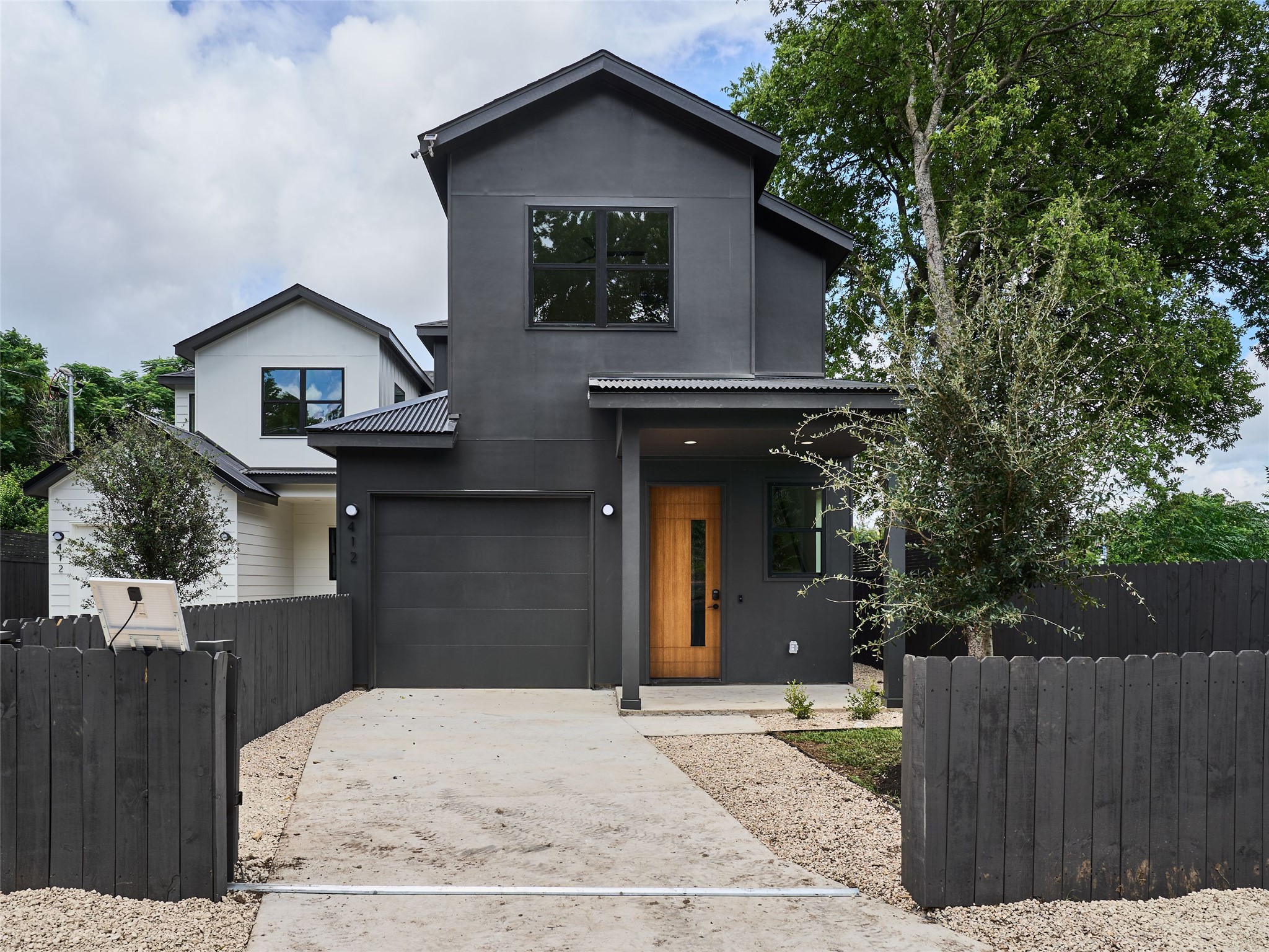 412 Hackberry Lane, Unit 2 Austin, TX 78753 - Photo 38 of 40 Modern home with concrete driveway and a garage
