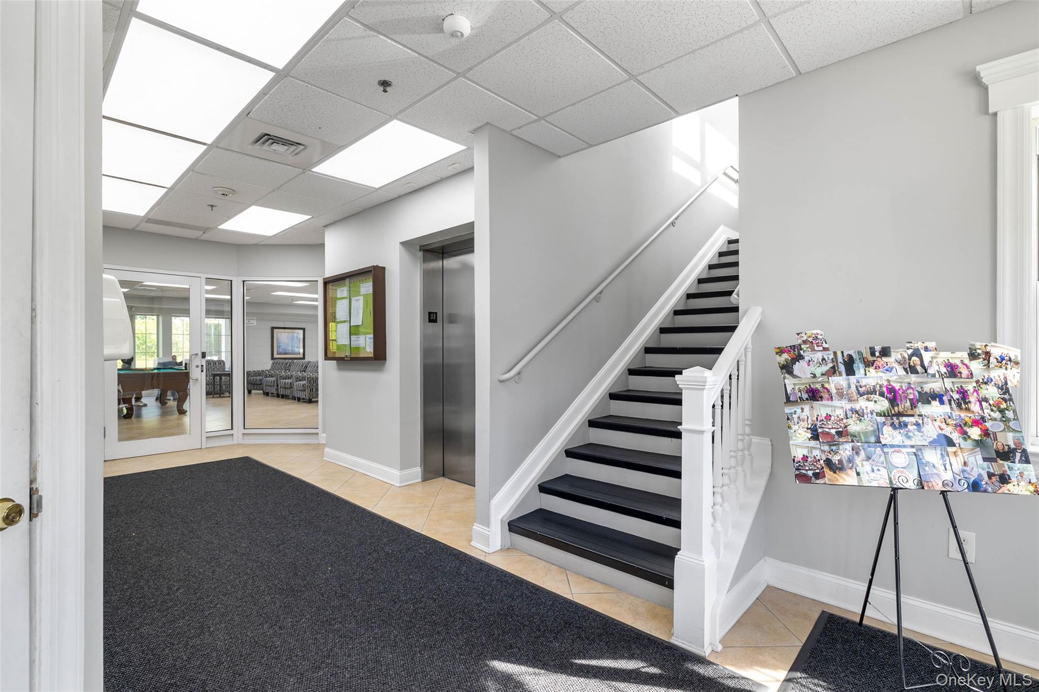 121 Willow Lane Valley Stream, NY 11580 - Photo 26 of 30 Stairs with tile patterned floors, a drop ceiling, and elevator