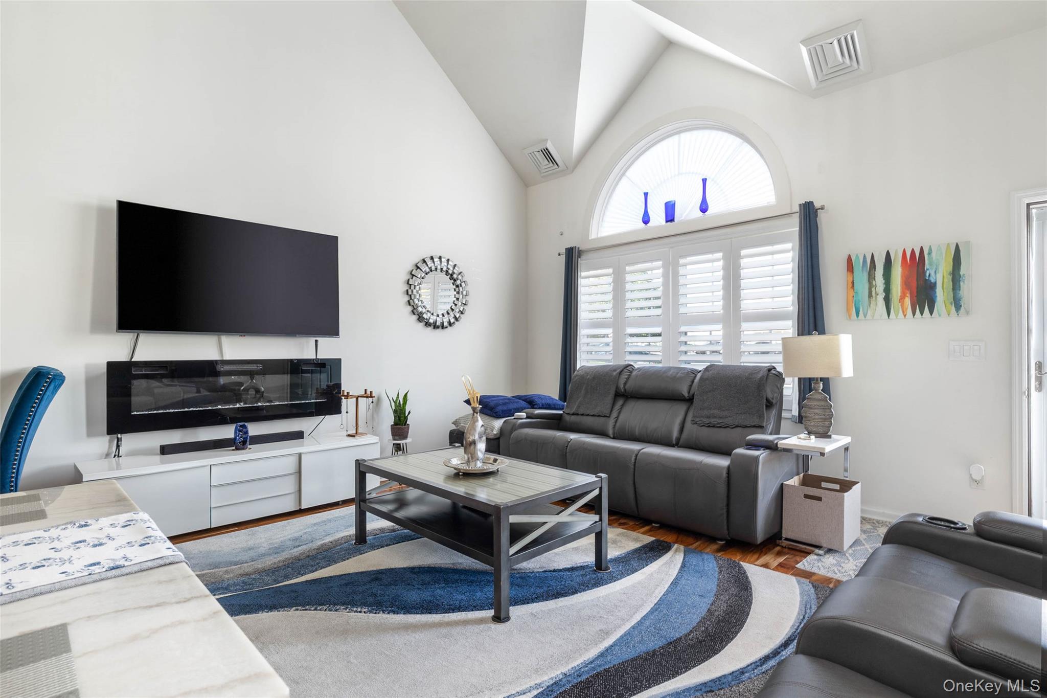 121 Willow Lane Valley Stream, NY 11580 - Photo 6 of 30 Living room featuring high vaulted ceiling and wood finished floors