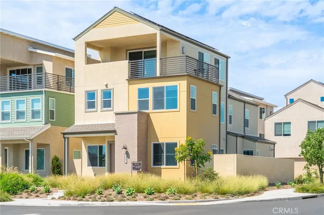 a front view of a residential apartment building with a yard