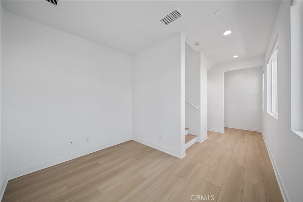 187 Yugen Irvine, CA 92618 - Photo 13 of 31 an empty room with wooden floor and windows
