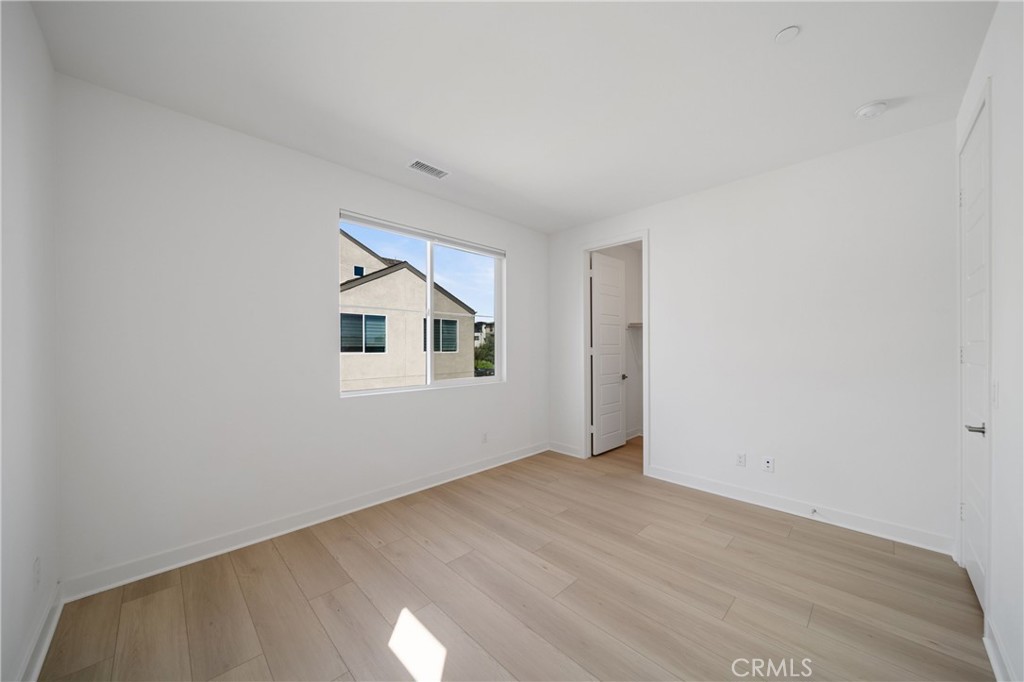 187 Yugen Irvine, CA 92618 - Photo 24 of 31 an empty room with wooden floor and windows